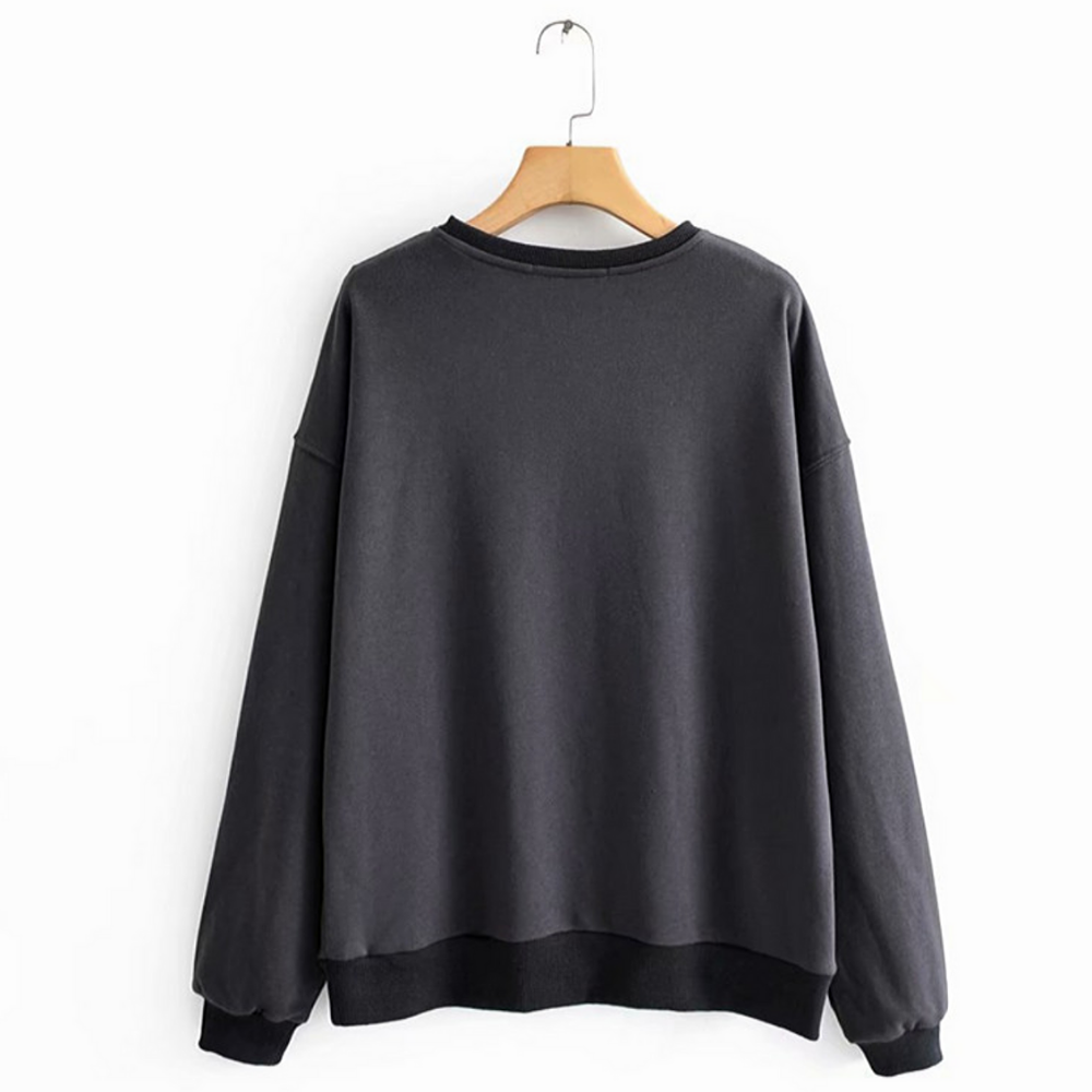 Pull noir cassé sur cintre.